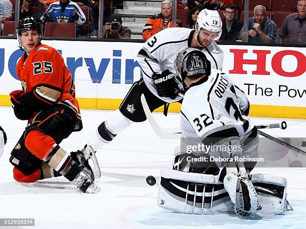 Jonathan Quick of the Los Angeles Kings blocks a shot in front of teammate Kyle Clifford and Mike Santorelli of the Anaheim Ducks on February 28,...