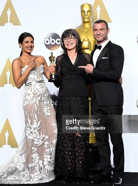 Editor Margaret Sixel , winner of the Best Film Editing award for 'Mad Max: Fury Road,' poses with actress Priyanka Chopra and actor Liev Schreiber...