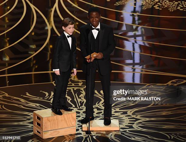 Actor Jacob Tremblay and Actor Abraham Attah present on stage at the 88th Oscars on February 28, 2016 in Hollywood, California. AFP PHOTO / MARK...