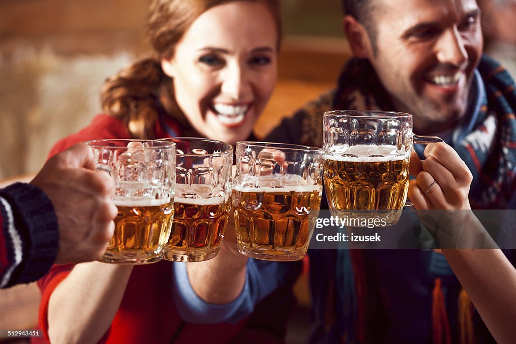 Friends toasting with beer