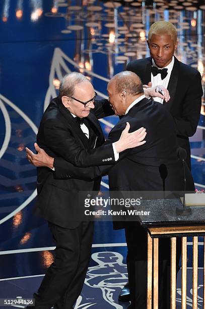 Composer Ennio Morricone accepts the Best Original Score award for ''The Hateful Eight' from musicians Quincy Jones and Pharrell Williams onstage...