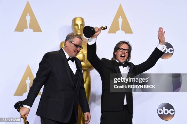 Adam McKay and Charles Randolph pose with their trophies for "The Big Short" in the press room during the 88th Oscars in Hollywood on February 28,...