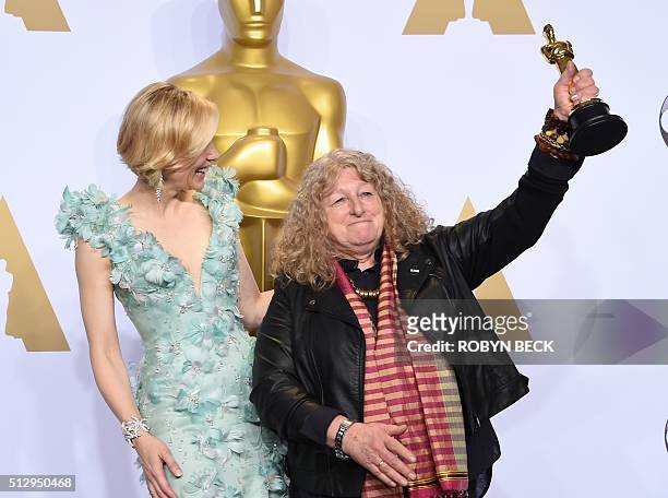 Actress Cate Blanchett watches as Jenny Beavan celebrates with her Oscar for Best Costume Design, "Mad Max: Fury Road," in the press room during the...