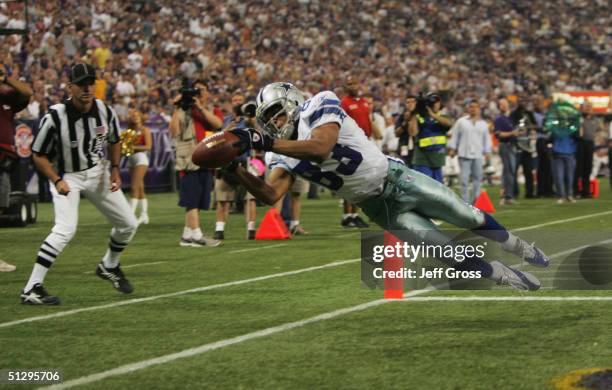 Terry Glenn of the Dallas Cowboys catches a pass for a touchdown in the second quarter against the Minnesota Vikings at Hubert H. Humphrey Metrodome...