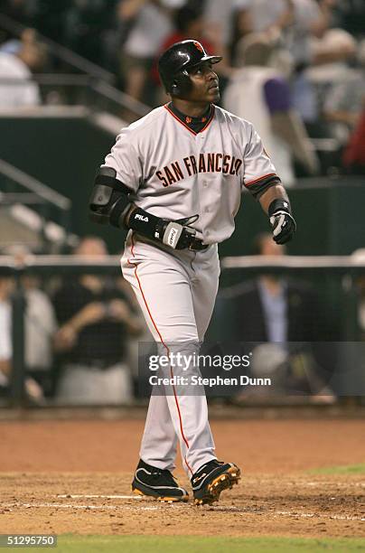 Barry Bonds of the San Francisco Giants watches his 699th career home run as it goes out of the park in the ninth inning against the Arizona...