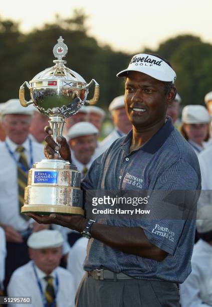 Vijay Singh of Fiji smiles with the trophy after his win in a playoff over Mike Weir of Canada during the final round of the Canadian Open at the...