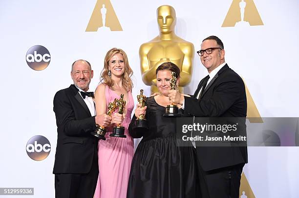 Producers Steve Golin, Nicole Rocklin, Blye Pagon Faust, and Michael Sugar, winners of Best Picture for "Spotlight," pose in the press room during...