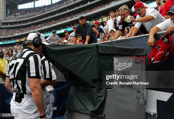 Referee Bill Leavy reviews a San Diego Chargers touchdown on instant replay during a break in action against the Houston Texans on September 12, 2004...