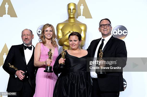 Producers Steve Golin, Blye Pagon Faust, Nicole Rocklin and Michael Sugar, winners of the Best Picture award for 'Spotlight,' pose in the press room...