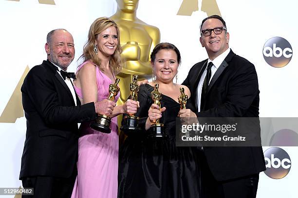 Producers Steve Golin, Blye Pagon Faust, Nicole Rocklin and Michael Sugar, winners of the Best Picture award for 'Spotlight,' pose in the press room...