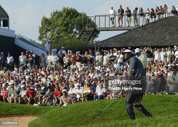 Vijay Singh of Fiji watches his shot from the bunker on the 18th green during the final round of the Canadian Open at the Glen Abbey Golf Club on...