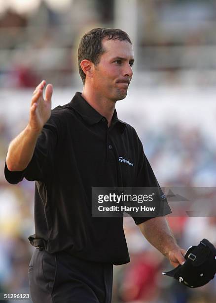 Dejected Mike Weir of Canada waves as he leaves the 18th green after loosing to Vijay Singh of Fiji in a playoff during the final round of the...