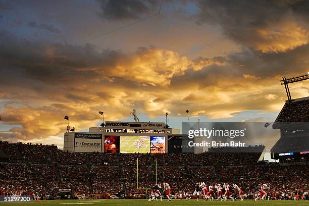 The sun sets as the Denver Broncos play the Kansas City Chiefs on September 12, 2004 at Invesco Field at Mile High Stadium in Denver, Colorado. The...