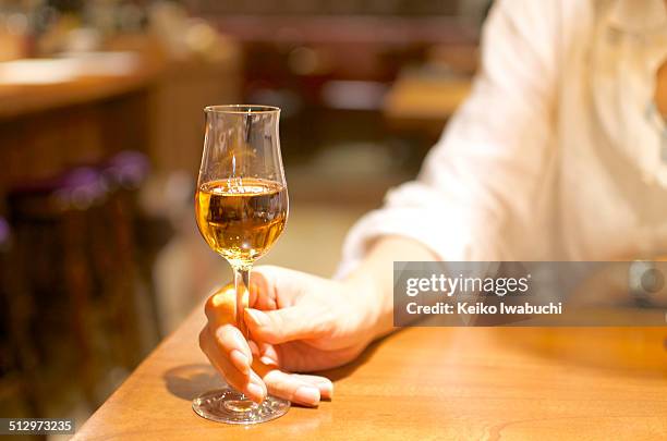 woman holding a glass of sherry - sherry stock pictures, royalty-free photos & images