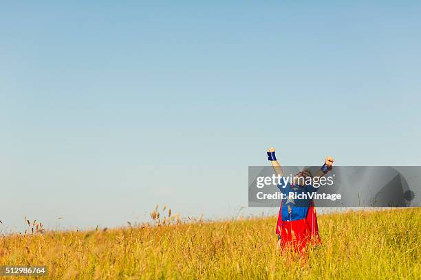 young boy dressed as superhero imagines flying - kids proud stock pictures, royalty-free photos & images