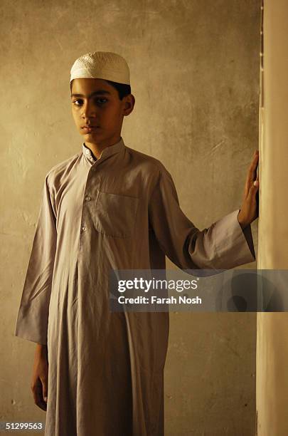 Shia Muslim boy stands in his home July 5, 2004 in Iraq. The boy has been studying Howza Elmiya for three years.