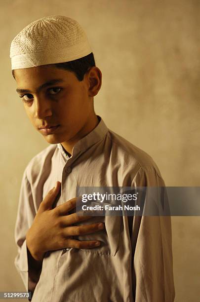 Shia Muslim boy stands in his home July 5, 2004 in Iraq. The boy has been studying Howza Elmiya for three years.
