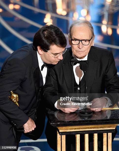 Composer Ennio Morricone accepts the Best Original Score award for 'The Hateful Eight' onstage with Italian interpreter during the 88th Annual...