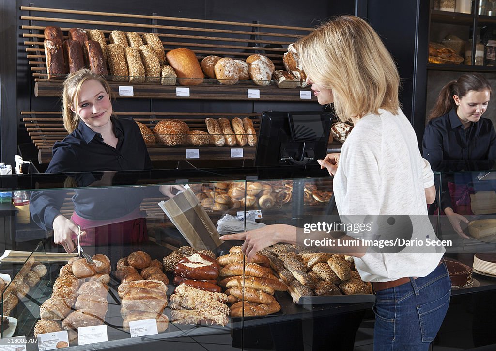 Blonde woman buying organic pastries in a bakery