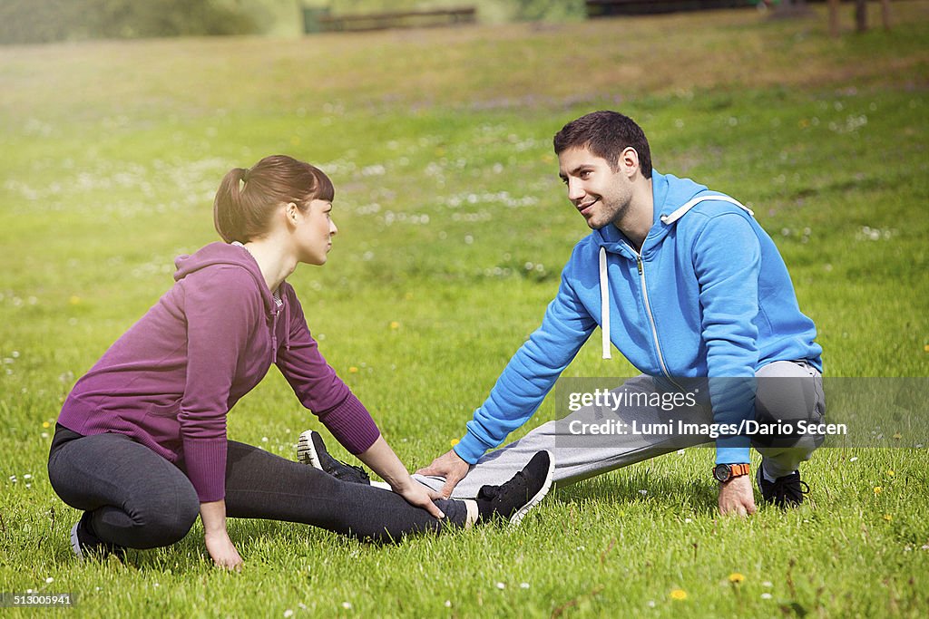 Young couple stretching in park, Osijek, Croatia