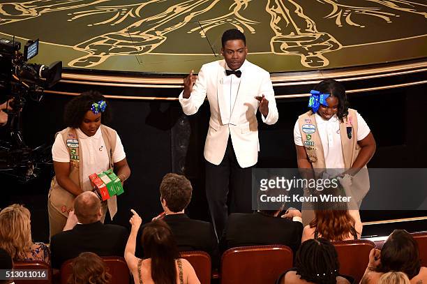 Host Chris Rock and Girl Scouts sell cookies to audience members during onstage during the 88th Annual Academy Awards at the Dolby Theatre on...