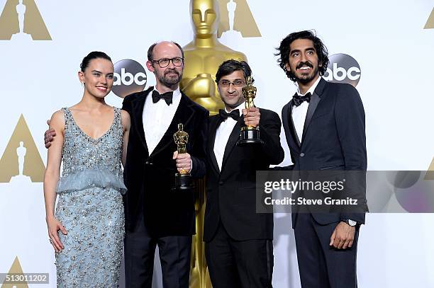 Filmmakers James Gay-Rees and Asif Kapadia , winners of the Best Documentary Feature award for 'Amy,' pose with actress Daisy Ridley and actor Dev...