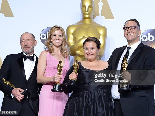 Producers Steve Golin, Blye Pagon Faust, Nicole Rocklin and Michael Sugar, winners of the Best Picture award for 'Spotlight,' pose in the press room...