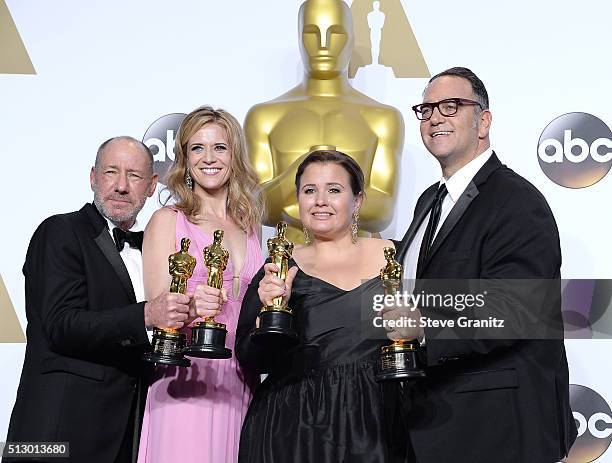 Producers Steve Golin, Blye Pagon Faust, Nicole Rocklin and Michael Sugar, winners of the Best Picture award for 'Spotlight,' pose in the press room...