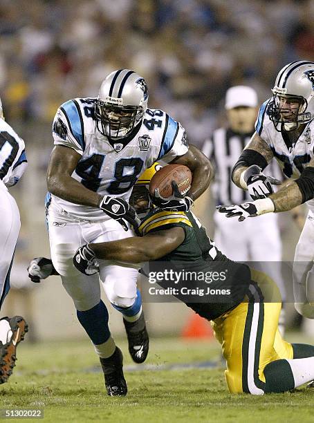 Cullen Jenkins of the Green Bay Packers tries to stop running back Stephen Davis of the Carolina Panthers on September 13, 2004 at Bank of America...