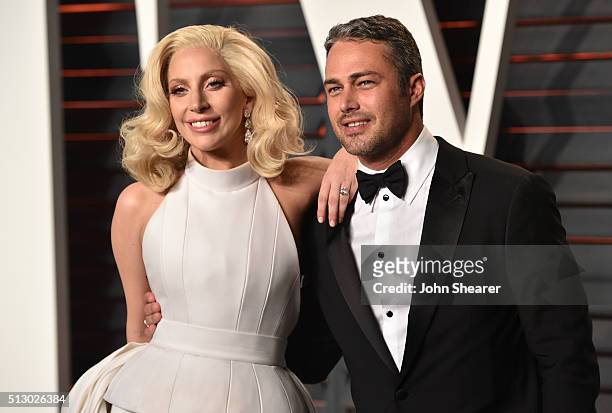 Recording artist Lady Gaga and Taylor Kinney arrive at the 2016 Vanity Fair Oscar Party Hosted By Graydon Carter at Wallis Annenberg Center for the...