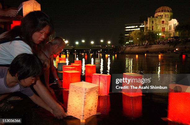 People release candle-lit colourful lanterns on the Motoyasugawa River on the 59th anniversary of the Hiroshima A-bomb dropping on August 6, 2004 in...