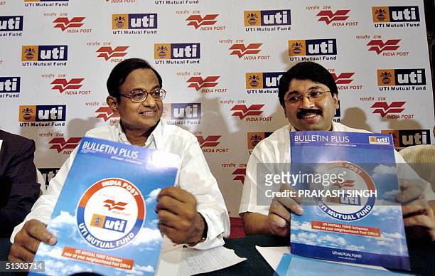 Indian Minister of Finance P. Chidambaram and Indian Minister of Communications and Information Technology Dayanidhi Maran show a booklet released by...