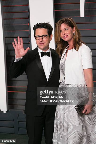 Director J.J. Abrams and his wife Katie McGrath pose as they arrive to the 2016 Vanity Fair Oscar Party in Beverly Hills, California on February 28,...