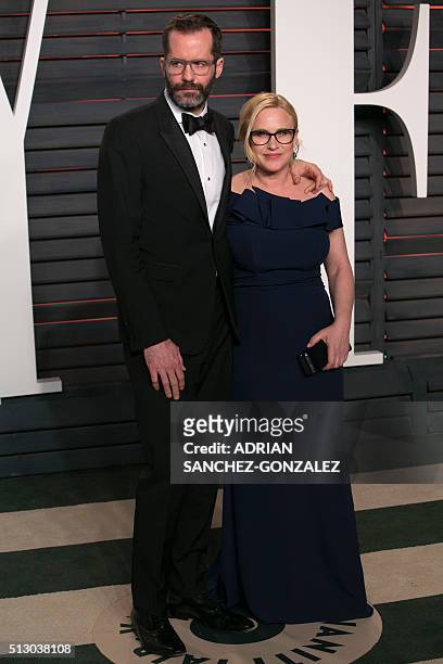 Actress Patricia Arquette and her partner Eric White pose as they arrive to the 2016 Vanity Fair Oscar Party in Beverly Hills, California on February...