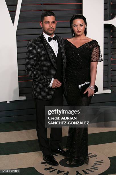 Actor Wilmer Valderrama and US singer Demi Lovato pose as they arrive to the 2016 Vanity Fair Oscar Party in Beverly Hills, California on February...