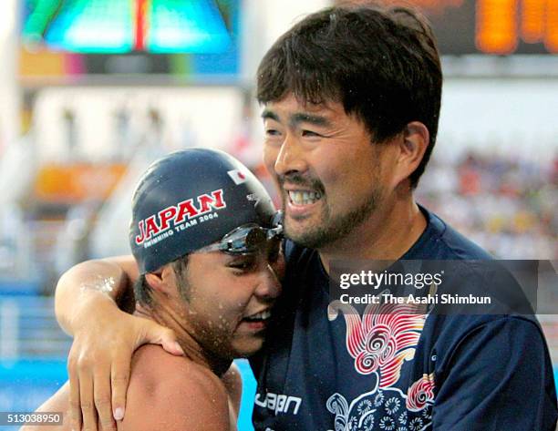 Kosuke Kitajima of Japan celebrates winning the gold in the Swimming Men's 200m Breaststroke with his coach Norimasa Hirai at the Athens Olympic...