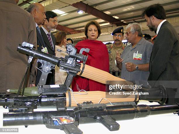 First Lady Begum Sehba Musharraf visits a stall during during a tour of the International Defence Exhibition & Seminar September 14, 2004 in Karachi,...