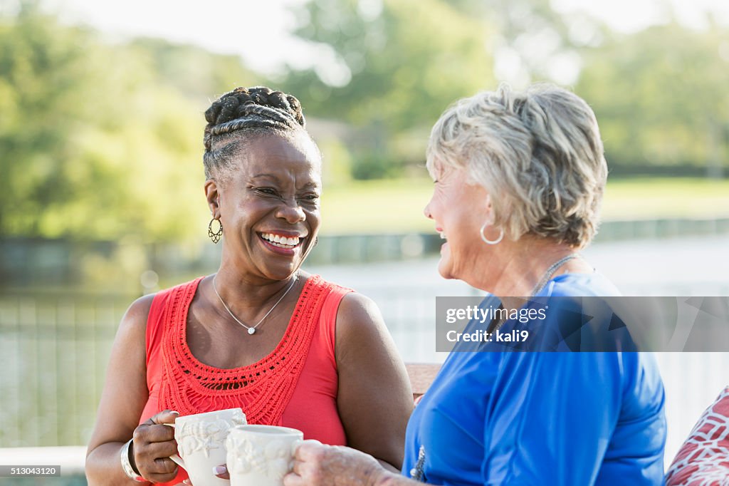 Senior women enjoying cup of coffee in back yard