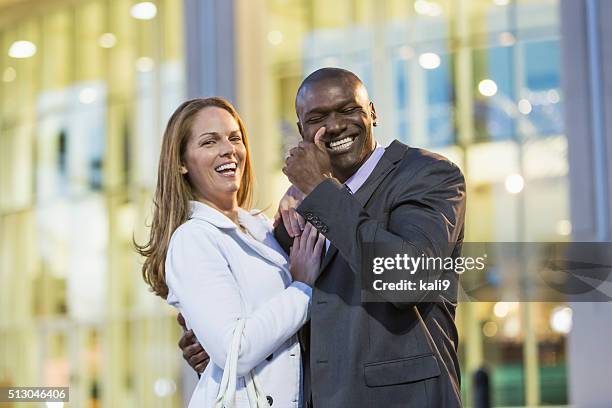 happy multi-racial couple outdoors, man wearing suit - boyfriend crying stock pictures, royalty-free photos & images