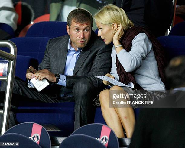 Chelsea's owner Russian Roman Abramovich chats with his wife, 14 September 2004 at the Parc des Princes stadium in Paris, during the Champions League...