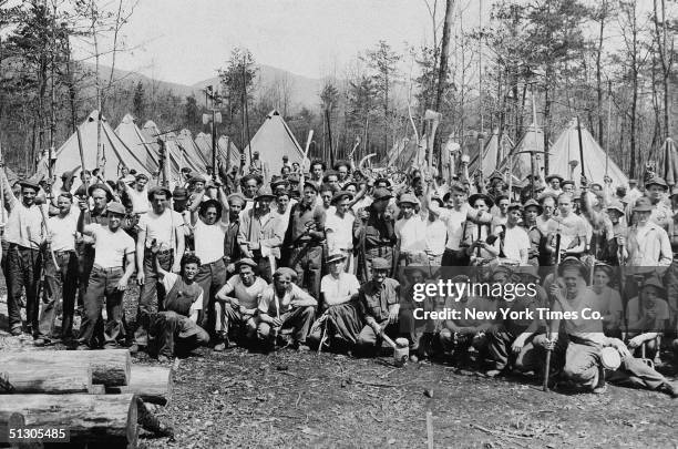 Members of the Civilian Conservation Corps Reforestation Camp pose with their tools, Luray, Virginia, April 18, 1933. The CCC was a New Deal-era...