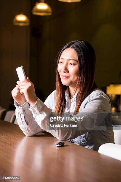 woman with diabetes checking her levels on a glaucometer - glaucometer stockfoto's en -beelden