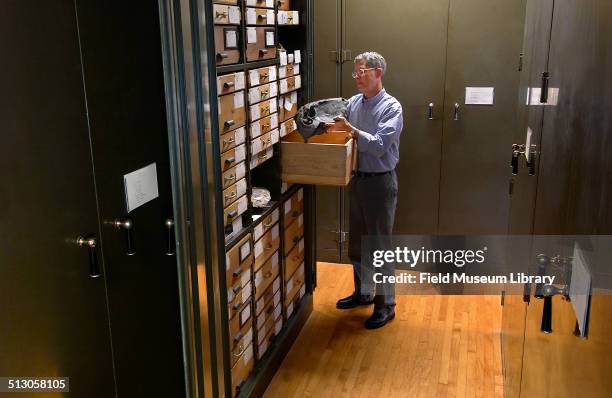 William 'Bill' Simpson standing by an open cabinet in the Permian Reptile Collection storage room, in the 3rd floor Geology department, March 1987....
