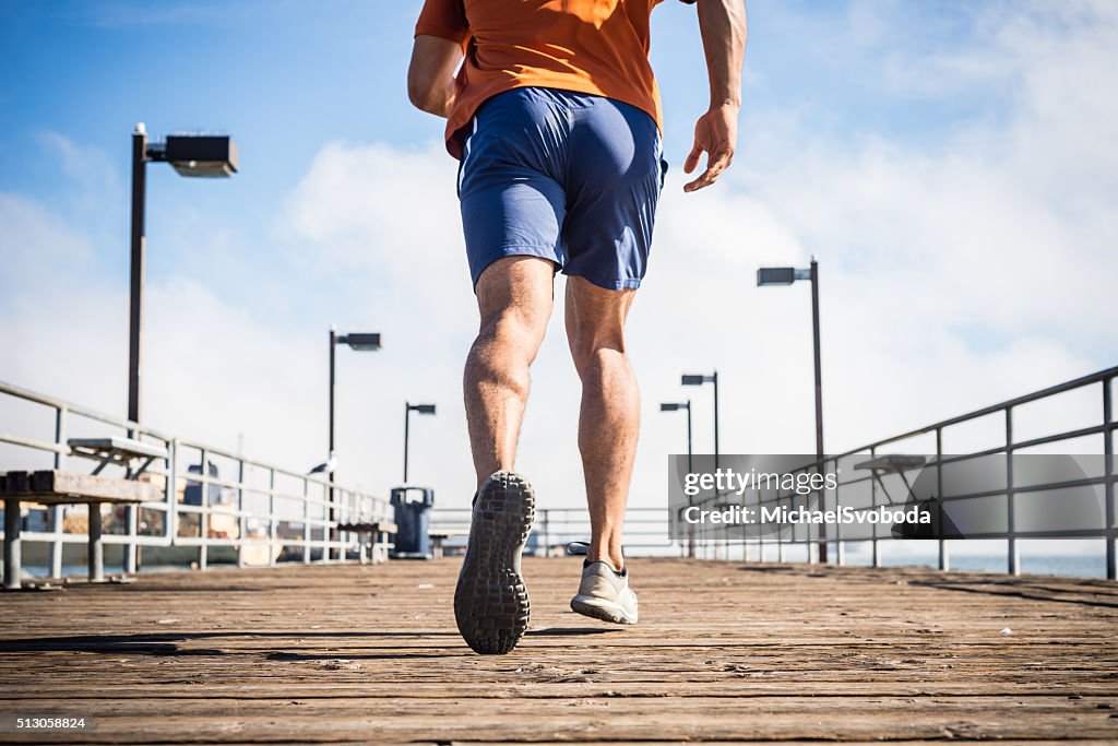 Male Runner Jogging On A Ocean Pier