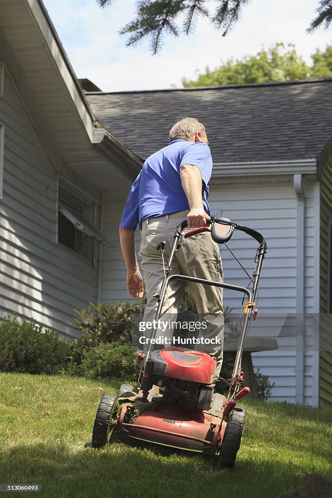 Man with Cerebral Palsy and dyslexia mowing his lawn