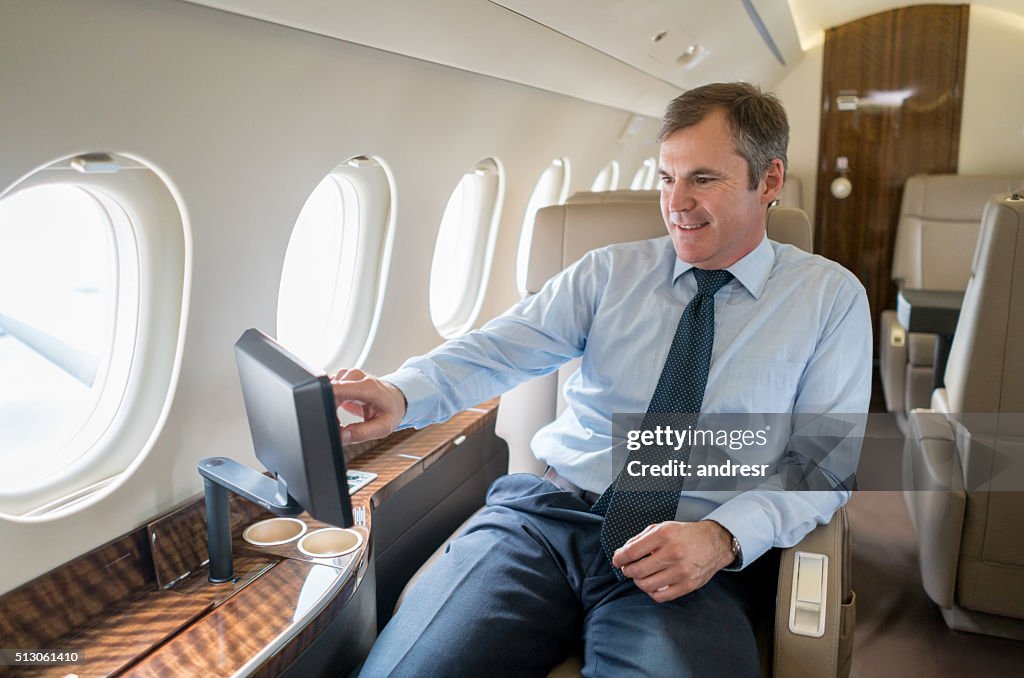 Business man traveling in a private jet