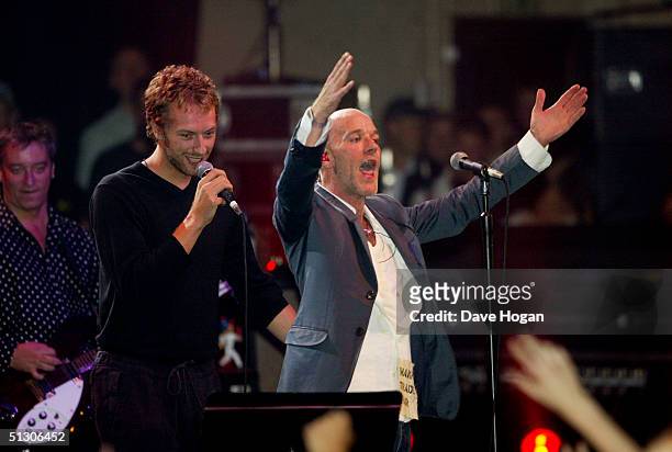 Chris Martin of 'Coldplay' and Michael Stipe of 'R.E.M.' perform on stage at the "Make Trade Fair Live" concert at the Carling Apollo Hammersmith...