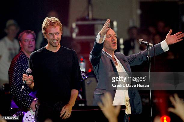 Chris Martin of 'Coldplay' and Michael Stipe of 'R.E.M.' perform on stage at the "Make Trade Fair Live" concert at the Carling Apollo Hammersmith...