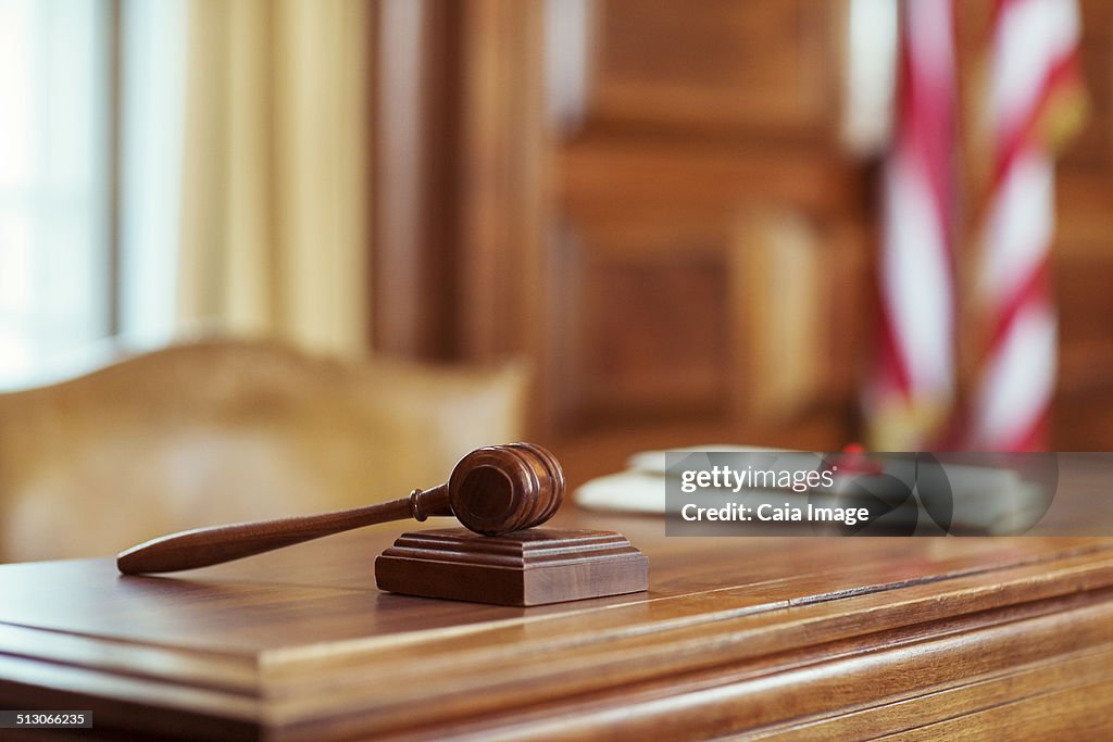 Gavel laying on judges bench in courtroom