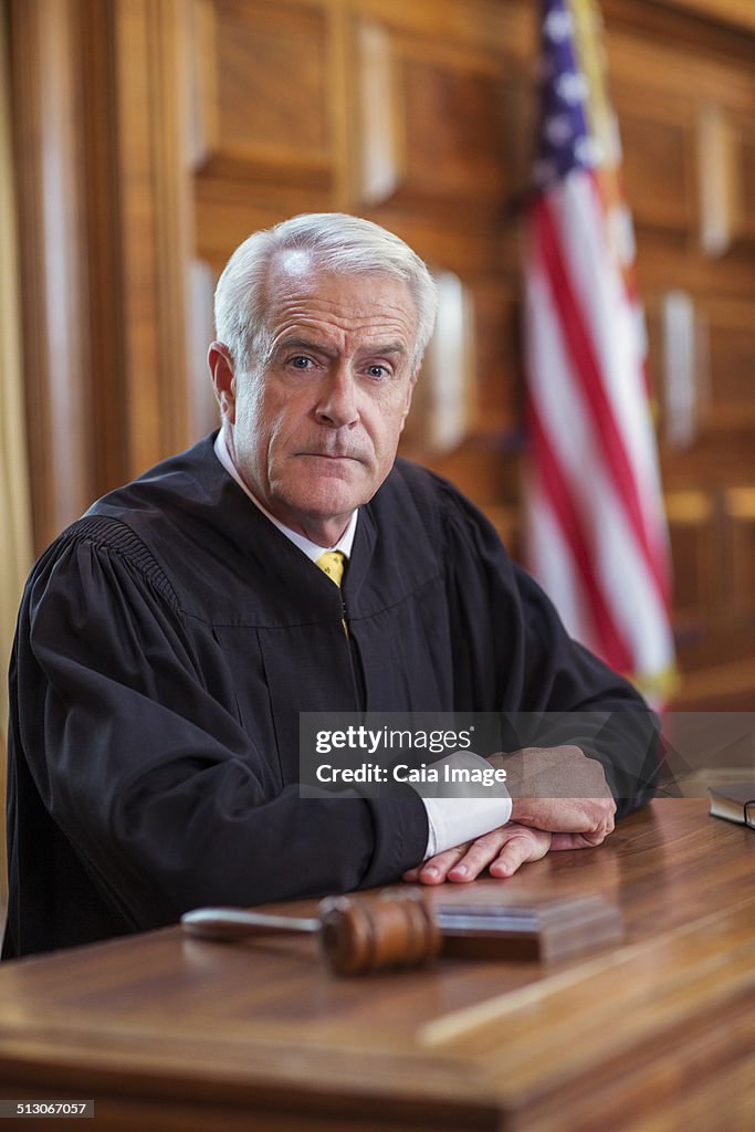 Judge sitting at judges bench in court